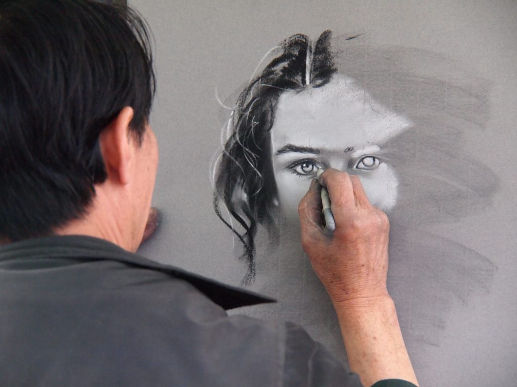 Man sketching portrait of a woman